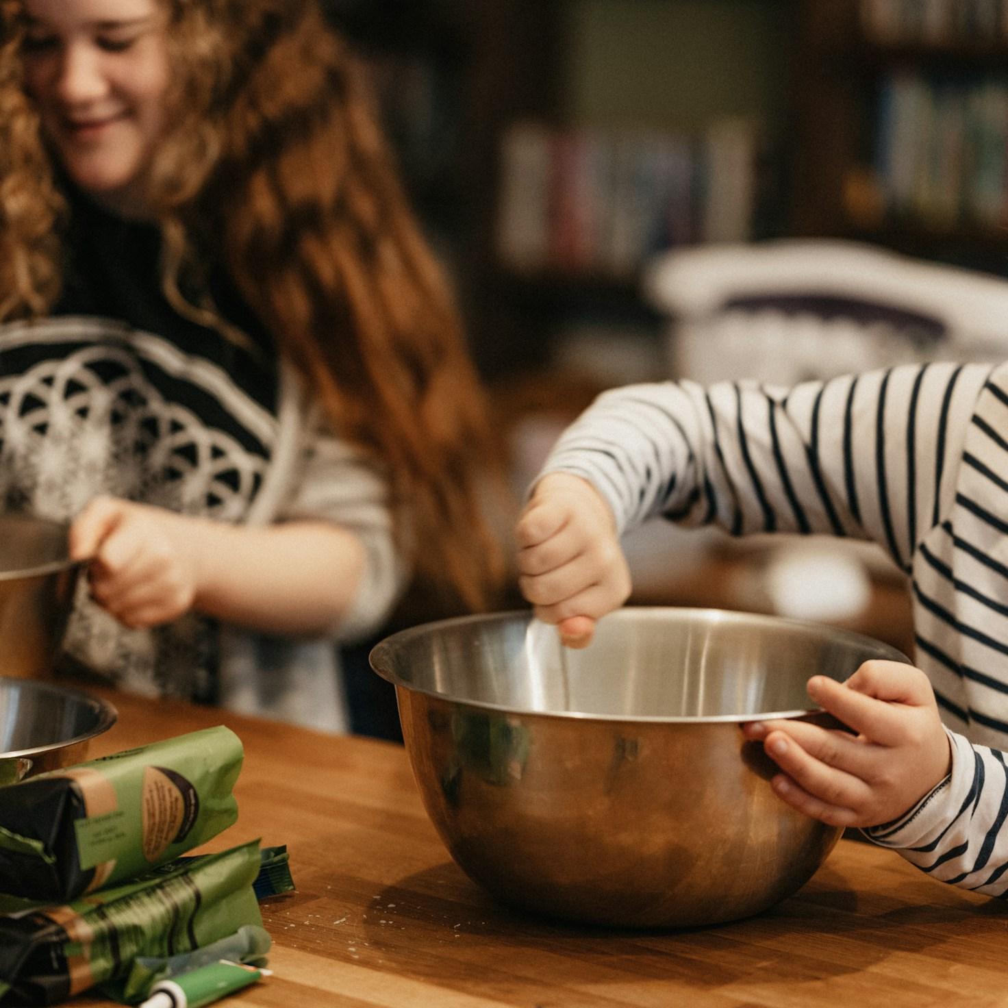 Community members collaborating in a modern kitchen space, sharing recipes and cooking techniques